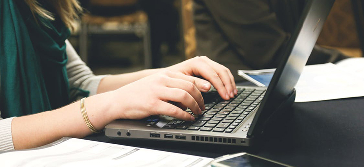 Woman typing on a laptop